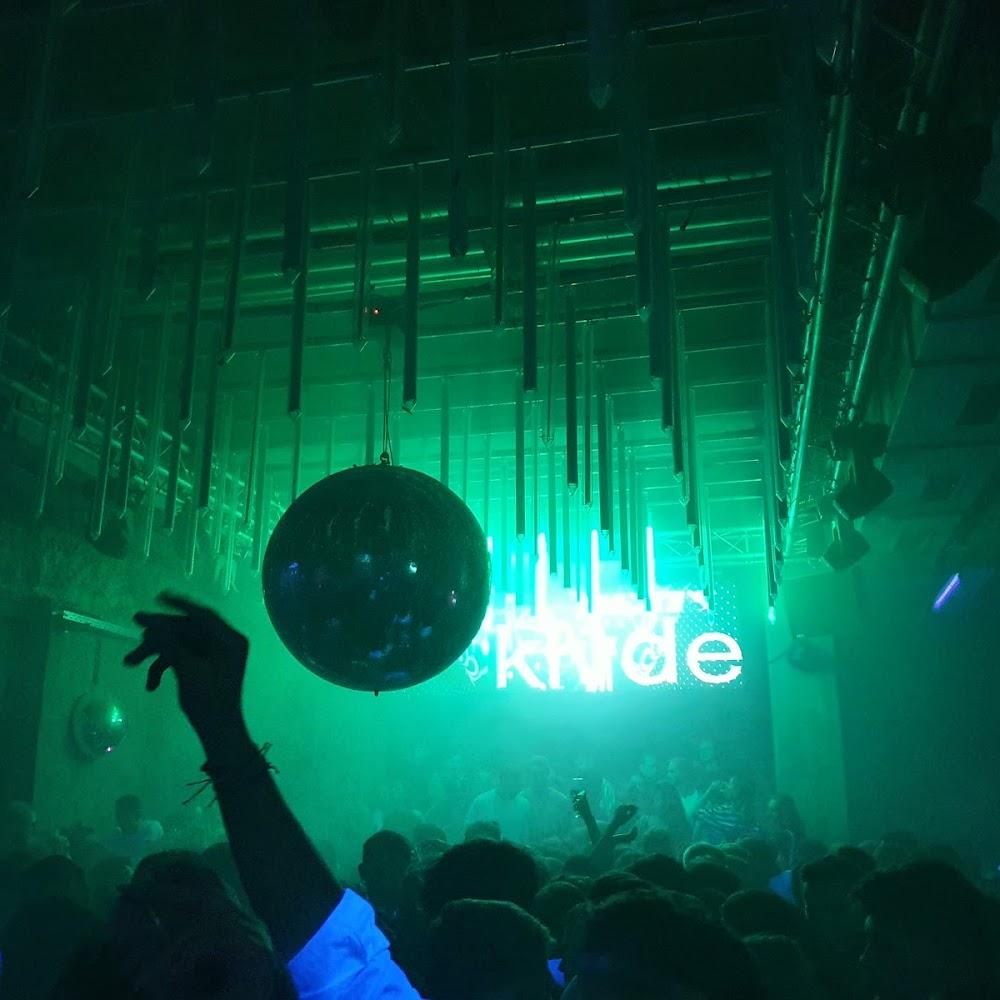 A disco ball hangs in a nightclub. The club is called 'Kinfolk'.
